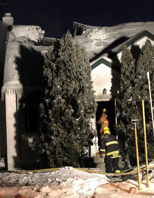 Winnipeg Fire Fighters at a home in the 1200 block of Fleet Ave. that was extensively damaged by an overnight fire. (WAYNE GLOWACKI/WINNIPEG FREE PRESS) Winnipeg Free Press  Jan.31  2013