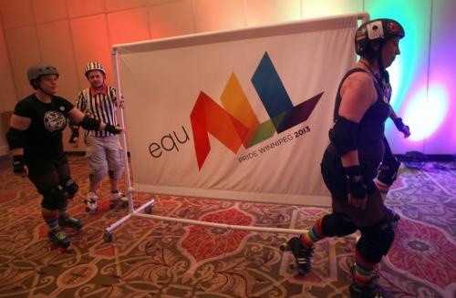 The new pride banner is rolled in via roller girls at the Pride 2103 launch Thursday at the Delta Hotel -See Gabrielle Giroday story- January 31, 2013   (JOE BRYKSA / WINNIPEG FREE PRESS)