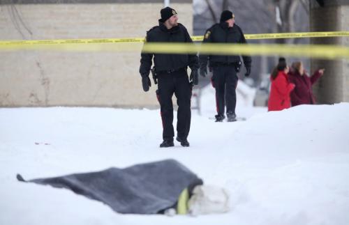 Winnipeg Police officers at an apartment complex in Tuxedo, Saturday, February 2, 2013. A blanket was being used to cover something in the courtyard. (TREVOR HAGAN/ WINNIPEG FREE PRESS)