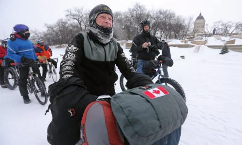 Lindsay Gauld, stopped in front of the Legislative building on his way along the Red River and past 1,000,000km's total on his bicycle, Saturday, February 2, 2013. (TREVOR HAGAN/WNNIPEG FREE PRESS)