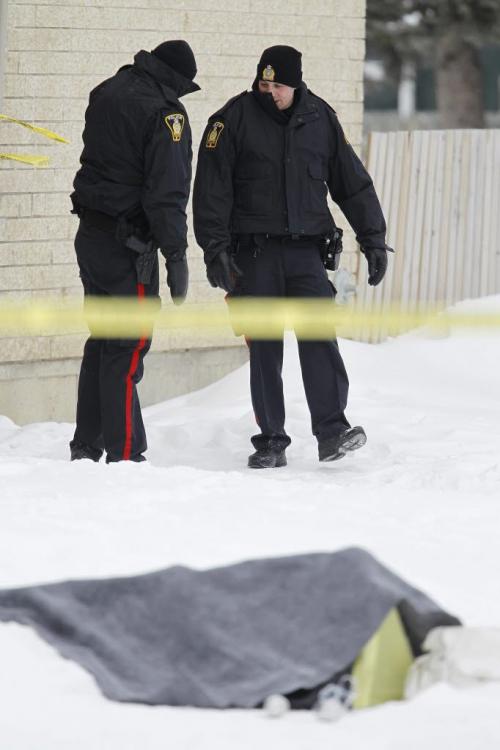 Police at a Manitoba Housing complex on Doncaster Street where a body was found Saturday, February 2, 2013. (TREVOR HAGAN/WNNIPEG FREE PRESS)