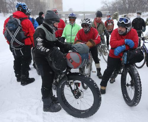 Lindsay Gauld, left, stopped in front of the Legislative building on his way along the Red River and past 1,000,000km's total on his bicycle, Saturday, February 2, 2013. (TREVOR HAGAN/WNNIPEG FREE PRESS)