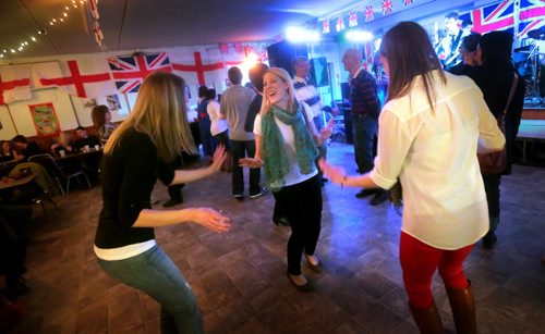Brandon Sun Friends Alana Martin, Jodi Mangin and Rinautta McConnell dance to the sounds of Until Red, who played a collection of British pop songs, on Saturday night at the English Pavilion during the Lieutenant Governor's Winter Festival. (Bruce Bumstead/Brandon Sun)