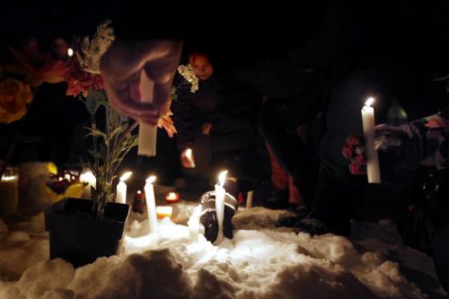 February 3, 2013 - 130203  -  Friends and family place candles in the snow at a vigil for Nadia Fiddler in the courtyard of a Manitoba Housing complex on Doncaster. Although not confirmed by police it is alleged that Fiddler was found dead in the courtyard Saturday February 2 2013. John Woods / Winnipeg Free Press