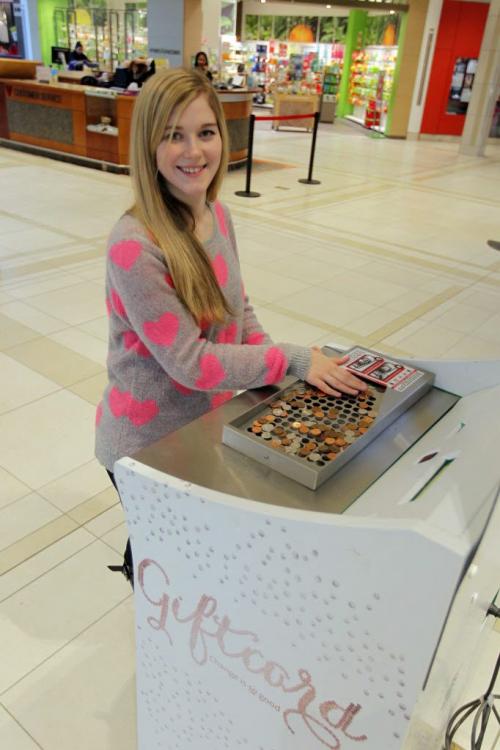 St. Vital Centre's Melissa Marlatt at the coin sorting machine that will turn all your change into a gift certificate for the mall. Please check city desk. Feburary, 4 2013  BORIS MINKEVICH / WINNIPEG FREE PRESS