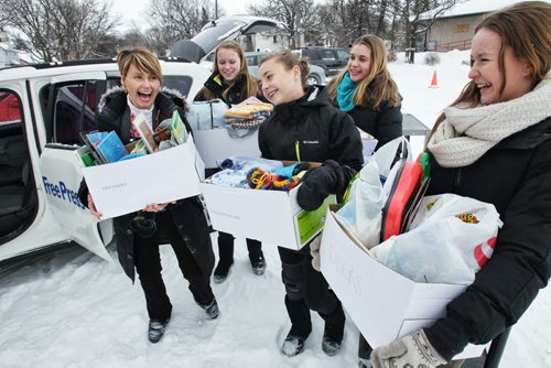 Winnipeg Free Press photojournalist Ruth Bonneville collects donations at Windsor School for a charity she is supporting through her church. Some of the students that are taking part the 2017 project overheard Ruth talking about her trip to Africa and spontaneously decided to start a collection. Thirteen year old Mackenzie, a grade 8 student at Windsor School took it upon herself to rally up her fellow students in her K - 8 school to donate baby items for a orphanage in Uganda. After hearing that Free Press staff photographer Ruth Bonneville was heading to Watoto, a baby orphanage in Gulu Africa she asked if she could help by collecting needed items for the kids. Mackenzie has been active in "We Day" activities which encourage students all over Manitoba to find ways to give back to others. She put together a letter for the students to take home and made presentations to her fellow students on the needs of the baby's in the orphanage In just a few weeks over 12 boxes were collected, everything from diapers to toys and books. The items were loaded up Tuesday afternoon to be packed in large duffle bags and sent with the group of volunteers with her church when they leave for Uganda on Saturday,Feb 16. 
Names - Ruth, Hailey, Aby (front in middle)  Mackenzie (rear) and Sydney. 130205 February 5, 2013 Mike Deal / Winnipeg Free Press