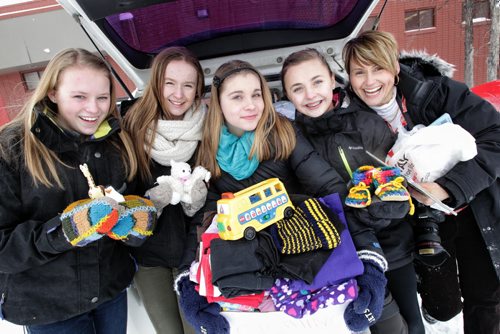 Winnipeg Free Press photojournalist Ruth Bonneville collects donations at Windsor School for a charity she is supporting through her church. Some of the students that are taking part the 2017 project overheard Ruth talking about her trip to Africa and spontaneously decided to start a collection. Thirteen year old Mackenzie, a grade 8 student at Windsor School took it upon herself to rally up her fellow students in her K - 8 school to donate baby items for a orphanage in Uganda. After hearing that Free Press staff photographer Ruth Bonneville was heading to Watoto, a baby orphanage in Gulu Africa she asked if she could help by collecting needed items for the kids. Mackenzie has been active in "We Day" activities which encourage students all over Manitoba to find ways to give back to others. She put together a letter for the students to take home and made presentations to her fellow students on the needs of the baby's in the orphanage In just a few weeks over 12 boxes were collected, everything from diapers to toys and books. The items were loaded up Tuesday afternoon to be packed in large duffle bags and sent with the group of volunteers with her church when they leave for Uganda on Saturday,Feb 16.
 Names from left - Hailey, Sydney, Mackenzie, Aby and Ruth 
 130205 February 5, 2013 Mike Deal / Winnipeg Free Press