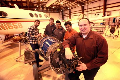 Business - Students with the Aviation and Aerospace program at Red River College work on engines at the Stevenson Campus on Saskatchewan Ave. with the Academic Coordinator - Christopher Walters.   See Martin cash  story on foreign students in program. Names  from left - Rajat  Arova (plaid, from India), Michael Mitchell, Alden Foncesca from India and Jairja  Shroff (India). Feb 05, 2013, Ruth Bonneville  (Ruth Bonneville /  Winnipeg Free Press)