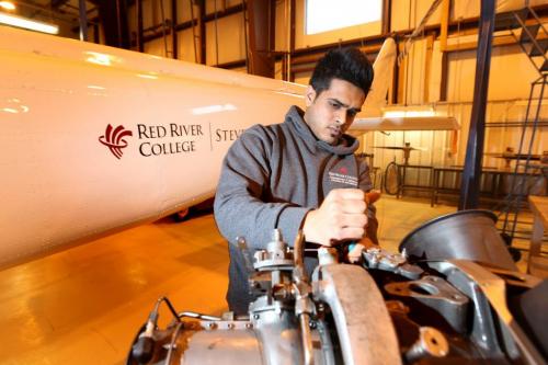 Business - Students with the Aviation and Aerospace program at Red River College work on engines at the Stevenson Campus on Saskatchewan Ave. with the Academic Coordinator - Christopher Walters.   See Martin cash  story on foreign students in program. Name of student - Alden Foncesca,  from India. Feb 05, 2013, Ruth Bonneville  (Ruth Bonneville /  Winnipeg Free Press)