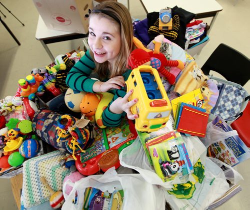 Thirteen year old Mackenzie, a grade 8 student at Windsor School took it upon herself to rally up her fellow students in her K -  8  school to donate baby items for a orphanage in Uganda. After hearing that Free Press staff photographer Ruth Bonneville was heading to Watoto, a baby orphanage in Gulu  Africa   she asked if she could help by collecting  needed items for the kids.  Mackenzie has been active in "We Day" activities which encourage students all over Manitoba to find ways to give back to others. She put together a  letter for the students to take home and made presentations to her fellow students on the needs of the baby's in the orphanage In just a few weeks over 12 boxes were collected, everything from diapers to toys ans books.  The items were loaded up Tuesday afternoon to be packed in large duffle bags and sent with the group of volunteers from he church when they leave for Uganda on Saturday,Feb 16.  Mackenzie is one of students in the 2017 project.
   Feb 05, 2013, Ruth Bonneville  (Ruth Bonneville /  Winnipeg Free Press)