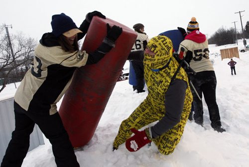 STDUP - Ice Donkey Winter Adventure 5km Obstacle Challenge preview event held at UofM on the old Southwood   Golf Course , the race will be held there  Feb 10 2012 ,in pic #53 Jenny Gompe with members of  Women's  Tackle Football Manitoba Fearless  team  blocks  "Dirty Donkey Ninja"  Deryk Ducharme took part  KEN GIGLIOTTI / FEB 6 2013 / WINNIPEG FREE PRESS