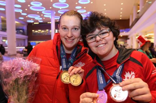 Special Olympics Manitoba athletes that competed in the 2013 Special Olympics World Winter Games in Korea in the past 2 weeks show off their medals after being  greeted by fans, friends and family at James Armstrong Richardson International Airport Wednesday night. Names of athletes -   Snowshoer, Ashlee McLeod - hair back.  Speed Skater, Beth Prendergast  - glasses, right .   Feb 06, 2013, Ruth Bonneville  (Ruth Bonneville /  Winnipeg Free Press)