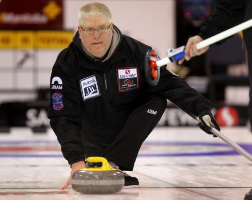 St Vital's Bruce Jones lets the granite go during the morning draw at the Safeway Championship in Neepawa. See Paul Weicek story. February 7, 2013 - (Phil Hossack / Winnipeg Free Press)