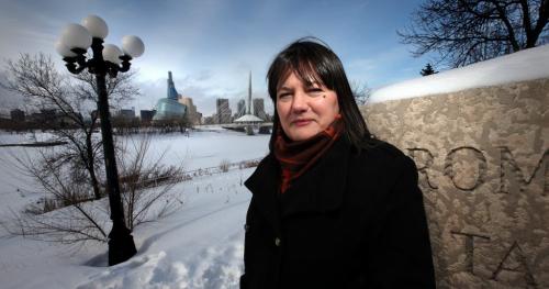 My Winnipeg's Jackie Shymanski poses at one of her favorite "vistas" on Tache, looking across the Red River at downtown Winnipeg. February 8, 2013. - (Phil Hossack / Winnipeg Free Press)