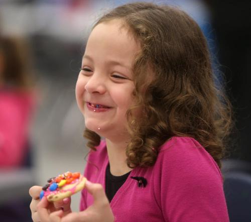 Kate Sala, 6, enjoys a cookie after decorating it herself at the Winter Carnival at Varsity View Community Centre, Saturday, February 9, 2013. (TREVOR HAGAN/WINNIPEG FREE PRESS)