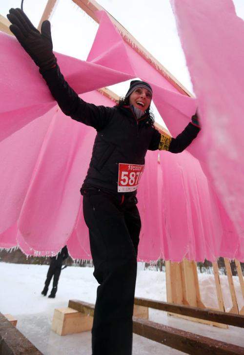 A participant make her way through the "Lick the Pole" obstacle during the Ice Donkey run at the University of Manitoba, Sunday, February 10, 2013. (TREVOR HAGAN/WINNIPEG FREE PRESS)