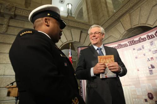 Premier Greg Sellinger , right , meets Petty officer first class Andre Sheppard at a ceremony Monday afternoon at the Manitoba Legislature unveiling-  Honouring black Canadians in the military-the display that will be at the Manitoba Legislature for the next month during black history month-Standup photo- February 11, 2013   (JOE BRYKSA / WINNIPEG FREE PRESS)