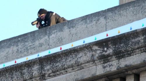What appears to be a city police officer photographs the Idle No More Rally at the Legislature from the roof Monday afternoon. Participants say they've seen the same officer numerous times at other rallys. See Carol Sanders story. February 11, 2013 - (Phil Hossack / Winnipeg Free Press)