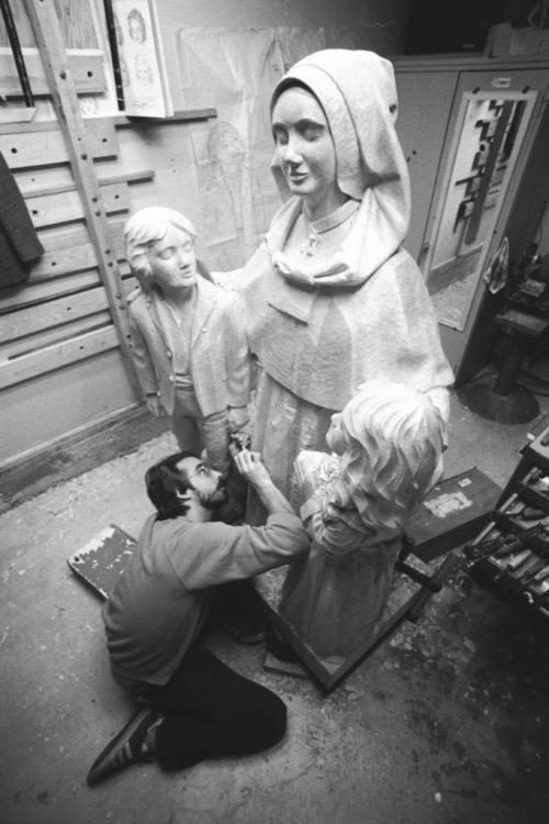 Sculptor Miguel Joyal puts the finishing touches on a basswood sculpture of Anne-Marie Rivier and two orphans. Anne-Marie Rivier was the founder of the order known as the Presentation of Mary. The piece, carved from a two by 1.3 metre block of wood, will be displayed athe the order's church in Prince Albert, Saskatchewan. October 18, 1986. Jim Haggarty / Winnipeg Free Press.