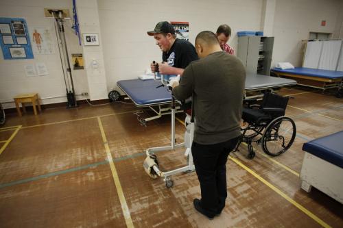 November 21, 2012 - 121121  -  Cole Maydanuk walks with his practice "tomato cage" legs and works with his therapist Ron Recuencoat a physiotherapy session at HSC Wednesday November 21, 2012. Maydanuk, the eldest son of Kim and Darryl Maydanuk was in a tragic workplace accident at the CN rail yards in Brandon on July 25, 2012 which resulted in the loss of both of his legs.  John Woods / Winnipeg Free Press