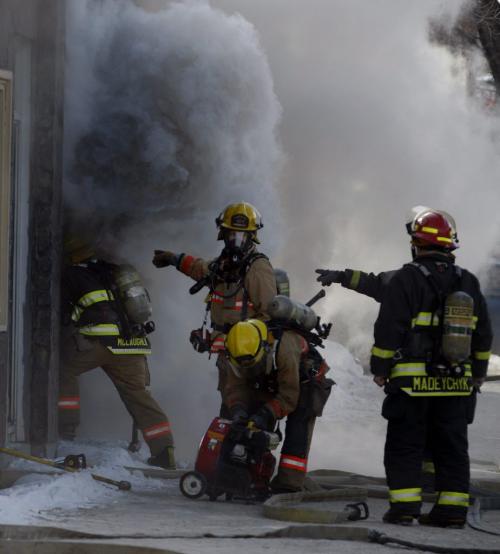 Fire fighters force there way into heavily involved  building =- Fire Vacant building 1051 Main St at Burrows Ave , firefighters met with heavy smoke and flame, a joining  Biggs Rock Island Pizza also heavily damaged , no injuries fire is out west bound Main is closed , the arson strike force is investigating   KEN GIGLIOTTI / FEB 12 2013 / WINNIPEG FREE PRESS