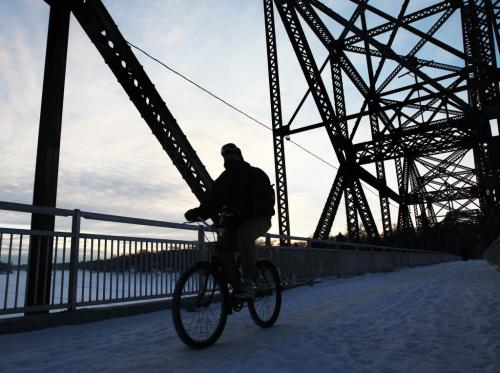 Morning Light- a cyclist drives over the pedestrian bridge towards Jubilee Ave in Winnipeg Wednesday morning Standup photo- February 13, 2013   (JOE BRYKSA / WINNIPEG FREE PRESS)
