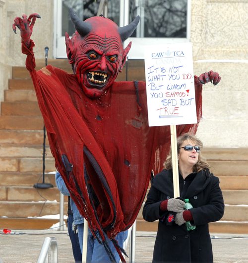More than 500 University of Manitoba union members rallied outside the administration building today to protest president David Barnard's policies. They accused U of M of widespread contracting out and privatization. This was a massive devil puppet that the CAW brought to the event. No ID given by the woman holding sign. Feb 13, 2013  BORIS MINKEVICH / WINNIPEG FREE PRESS