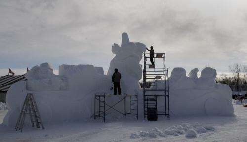 Final Preparations being done on snow scupture entrance   by right Dave Maddocks  and left Barry  Bonhan   titled Fiddle Me Home  , at the entrance  to the park - Festival du Voyageur starts Friday Feb 15 with a Torchlight Walk and opening ceremony  and daily events  running till Feb 24 , final preparations are being made  KEN GIGLIOTTI / FEB 14 2013 / WINNIPEG FREE PRESS