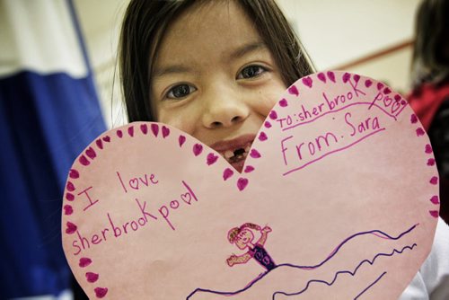 Sara Lewis, 6, holds up a valentine card she made while parents and neighbourhood residents discuss the issues surrounding the continued closure of the Sherbrook Pool several kids made valentines cards that will be put up on the side of the pool later this week.  130214 February 14, 2013 Mike Deal / Winnipeg Free Press