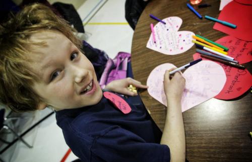 Aiden Dueck Thiessen, 9, finishes a valentine card he made while parents and neighbourhood residents discuss the issues surrounding the continued closure of the Sherbrook Pool several kids made valentines cards that will be put up on the side of the pool later this week.  130214 February 14, 2013 Mike Deal / Winnipeg Free Press