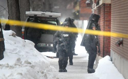 TAC Team members pack up their gear outside an apartment building on Sherbrook near Seargant Friday after waiting out suspects in a shooting on Main Street. See story.  February 15, 2013 - (Phil Hossack / Winnipeg Free Press)