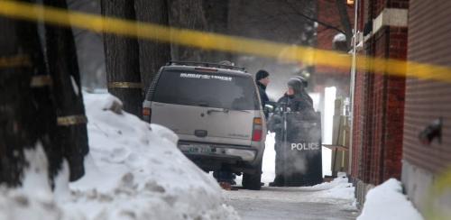 TAC Team members confer outside an apartment building on Sherbrook near Seargant Friday after waiting out suspects in a shooting on Main Street. See story.  February 15, 2013 - (Phil Hossack / Winnipeg Free Press)