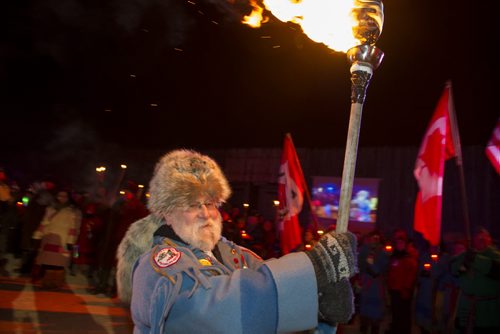 021513 Winnipeg-  George Einarson carries a torch during the opening ceremony of the 44th edition of the Festival du Voyageur Friday night at Voyageur Park. DAVID LIPNOWSKI / WINNIPEG FREE PRESS