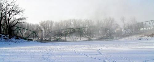 The smoke clears after the St. Jean Baptiste bridge was demolished around 9 AM Saturday morning in front of a gathering of townspeople and local residents.  130216 February 16, 2013 Mike Deal / Winnipeg Free Press