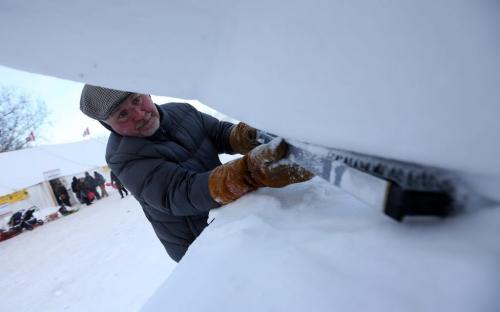 Lyle Peters works on a snow sculpture titled, "Chase" at the Festival du Voyageur, Saturday, February 16, 2013. (TREVOR HAGAN/WINNIPEG FREE PRESS)