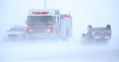 A vehicle sits on its roof on the North Perimeter near Brookside Blvd. Blowing snow caused poor visibility on the Perimeter and many vehicles wound up in the ditch, February 18, 2013. (TREVOR HAGAN/WINNIPEG FREE PRESS)