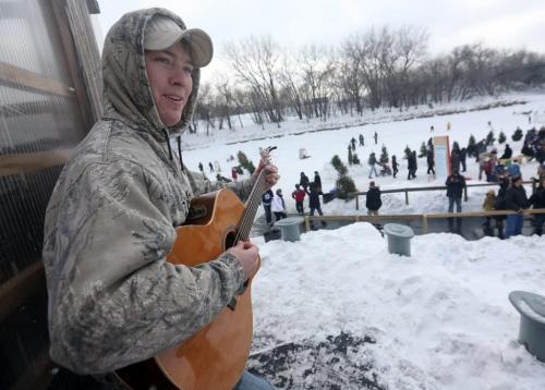 Josh Gareau plays guitar with Darryl St. Goddard and Melissa St. Goddard near a warming hut by the Assiniboie River at The Forks as part of the Music on Ice event, Sunday, February 17, 2013. (TREVOR HAGAN/WINNIPEG FREE PRESS)