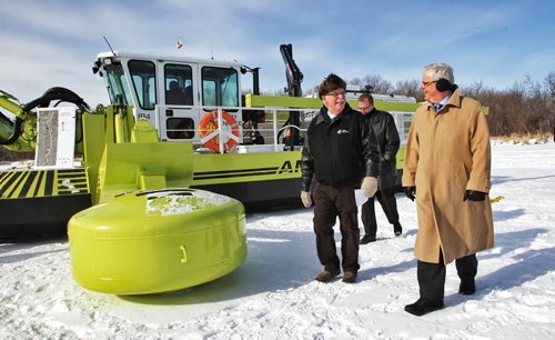 Premier Greg Selinger walks around one of the Amphibex units with Don Forfar the Reeve for the RM of St. Andrews. The fleet of Amphibex icebreaking machines have started the annual ice-jam prevention program on the Red River north of Selkirk, MB.  130220 February 20, 2013 Mike Deal / Winnipeg Free Press