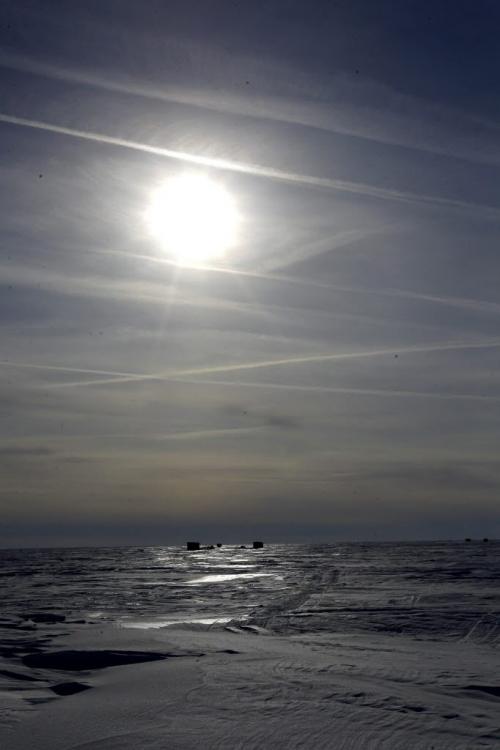 Sun shines over the East side of Lake Winnipeg just south of Grand Beach, Manitoba. On horizon is a some ice fishing shacks. Feb 20, 2013  BORIS MINKEVICH / WINNIPEG FREE PRESS