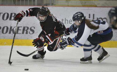 At right, Shaftesbury Titans defenceman Cydnee Cook is penalized for take down of Sarah Potomak forward on the Pursuit of Excellence team from Kelowna, BC  at the Female Sport School Challenge at the MTS Iceplex Friday morning.Ashley Prest story Wayne Glowacki/ Winnipeg Free Press Feb.22 2013