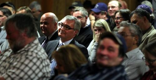Finance Minister and former Agriculture Minister Stan Struthers listens  to reaction from his seat in an angry crowd at the Marquette Hall after addressing producers and cottage/home owners about ongoing flood damage compensation Friday. See Redekopp's story. February 22, 2013 - (Phil Hossack / Winnipeg Free Press)