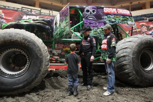 Dane Goodall-George 8 years had a a special meet and greet has been planned for a young car enthusiast from The Dream Factory.  The 8-year-old friend of The Dream Factory will be brought to the MTS Centre for a special chance to see massive Monster Jam trucks up close Here he checks out Grave Digger with driver Jon Zimmer, right, and Cam McQuuen from Northern Nightmare, his truck not pictured- Monster trucks will be revving all weekend at the MTS Centre-Standup photo- February 22, 2013   (JOE BRYKSA / WINNIPEG FREE PRESS)
