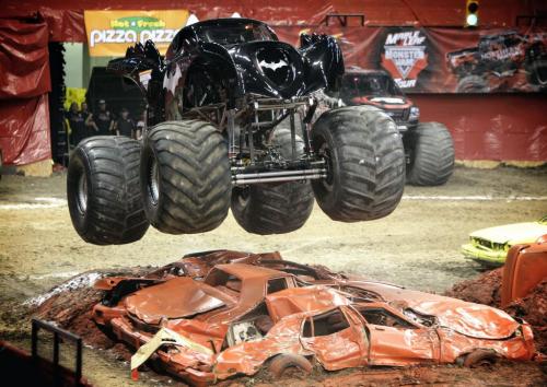 Driver Norm Miller soars over the cars with his truck Batman during a racing  competition at the Maple Leaf Monster Jam event at MTS Centre Saturday afternoon. 130223 February 23, 2013 Mike Deal / Winnipeg Free Press