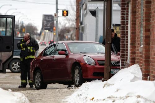 A car jumped the curb and hit the building at Arlington and Burrows Saturday afternoon. Injuries and damage to the building are undetermined.  130223 February 23, 2013 Mike Deal / Winnipeg Free Press