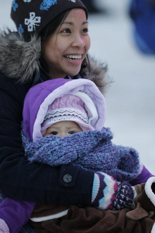 Noy Thepanya, and her daughter, Ariella, 6 months, from Toronto, enjoying a mild afternoon at the Festival du Voyageur, Saturday, February 23, 2013. (TREVOR HAGAN/WINNIPEG FREE PRESS)