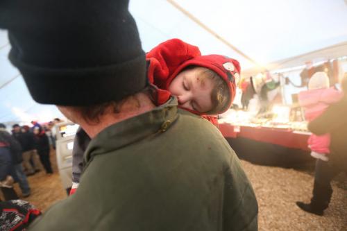 Father, Colin Watt, carrying a sleeping Addax Egan, 4, in the souvenir tent at the Festival du Voyageur, Saturday, February 23, 2013. (TREVOR HAGAN/WINNIPEG FREE PRESS)