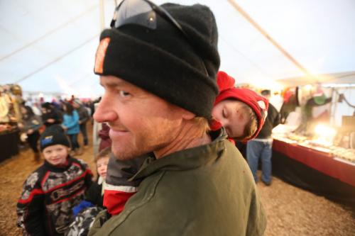 Father, Colin Watt, carries a sleeping Addax Egan, 4, in the souvenir tent at the Festival du Voyageur, Saturday, February 23, 2013. (TREVOR HAGAN/WINNIPEG FREE PRESS)