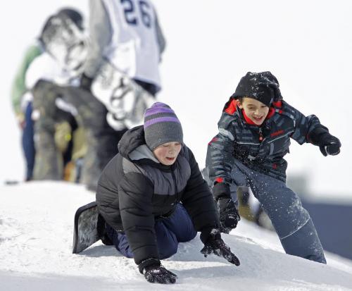 Frankie Triolla, 9, and Miguel Gomez,8, snowboarding in front of the Snow Jam Snowboarding Competition at The Forks, Sunday, February 24, 2013. (TREVOR HAGAN/WINNIPEG FREE PRESS)