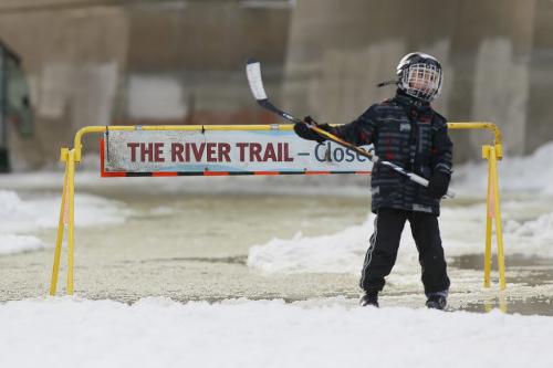 February 24, 2013 - 130224  - A young skater stops at a sign at the closed section of The River Trail on the Assiniboine River which was closed due to flooding Sunday February 24, 2013.  John Woods / Winnipeg Free Press