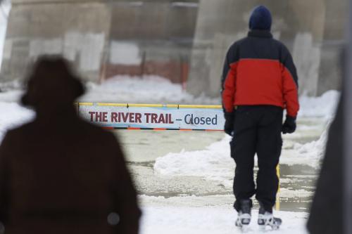 February 24, 2013 - 130224  - Skaters stop at a sign at the closed section of The River Trail on the Assiniboine River which was closed due to flooding Sunday February 24, 2013.  John Woods / Winnipeg Free Press